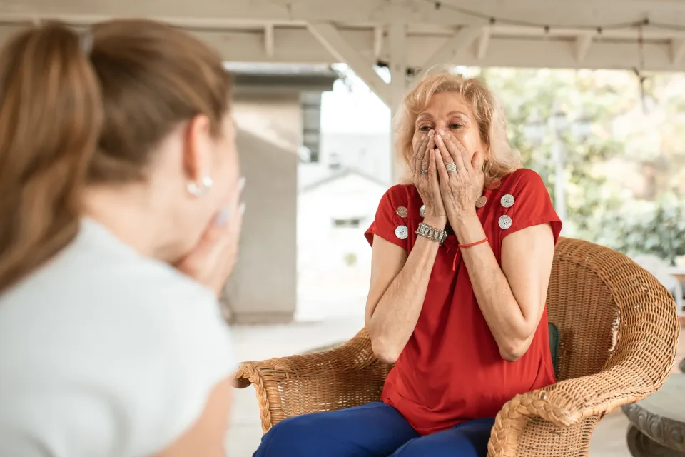 Older woman discussing support options with a professional