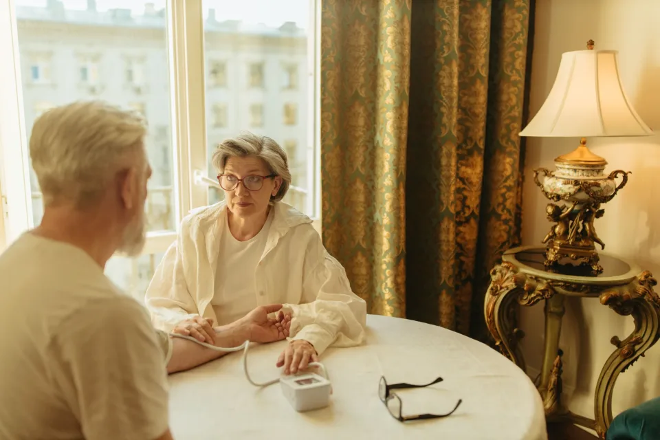 Older adult meeting with a care professional at a table