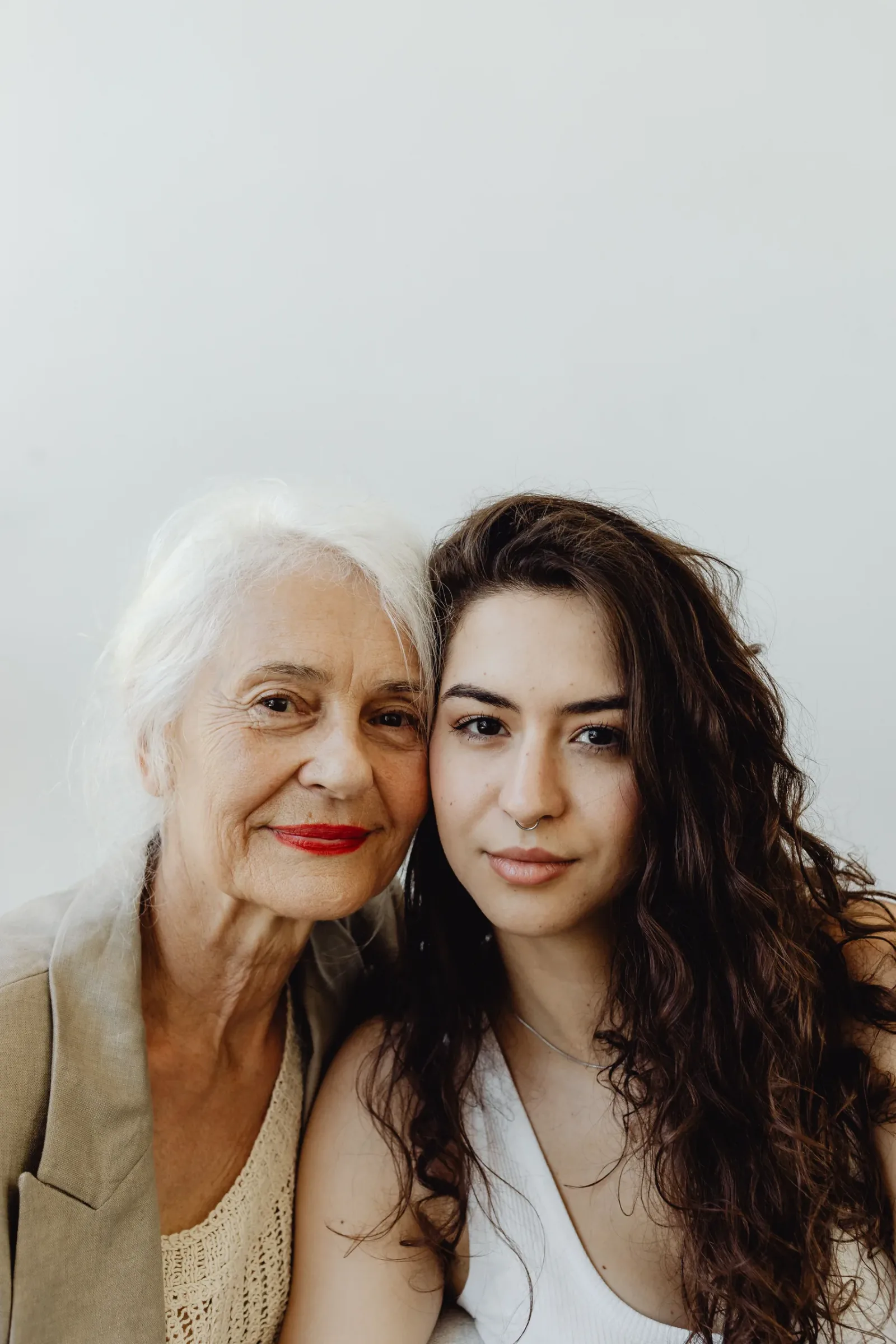Older woman and younger companion posing together for a portrait