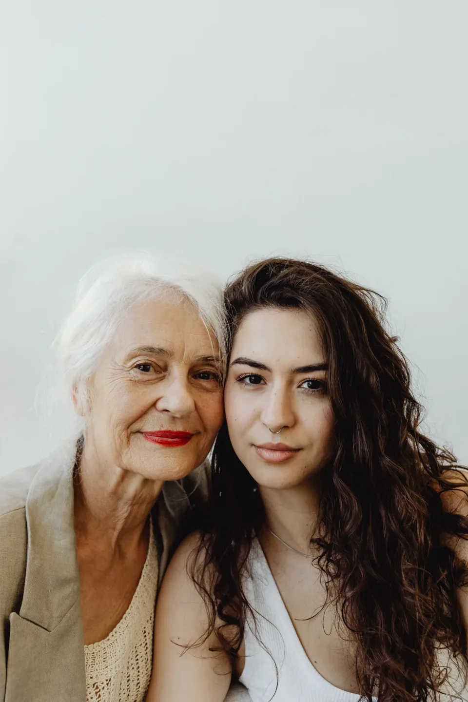 Older woman and younger companion posing together for a portrait