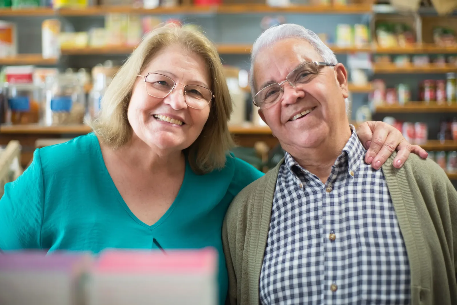 Smiling older couple shopping together at a grocery store